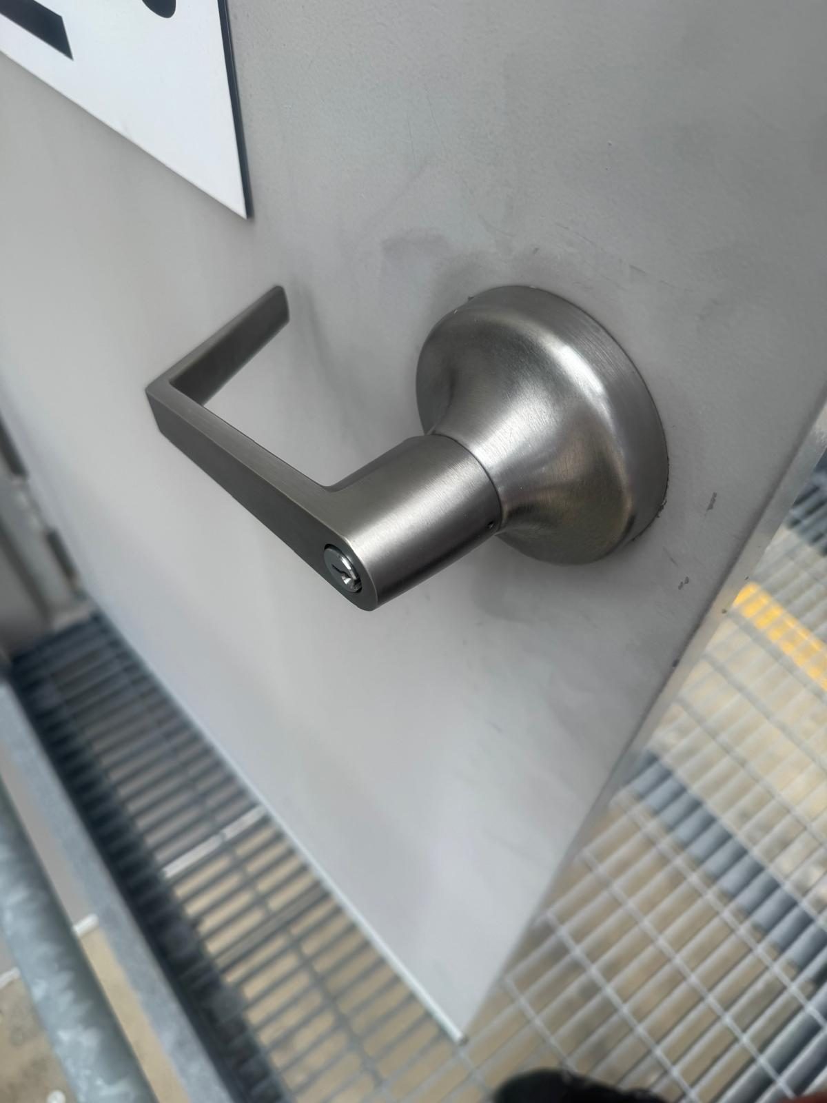 Commercial-grade lever handle installation, close-up detail
